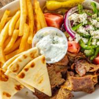 Gyro Dinner · Gyro slices served with Greek salad and fries with tzatziki sauce and pita bread.