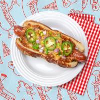 The Chili Cheese Dog · Hot dog topped with chili, jalapenos, sliced onion, scallions, and shredded cheese, served o...