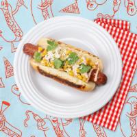 The Elote Dog · Hot dog topped with corn, cilantro, cotija cheese, and spicy mayo on a bun.