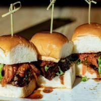 Caramelized Short Rib Sliders · Korean BBQ short ribs with a kimchi slaw, Monterey Jack cheese, and a sesame dressing