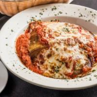 Eggplant Parmigiana · Spaghetti noodles smothered in marinara sauce topped with lightly breaded fried eggplant bak...