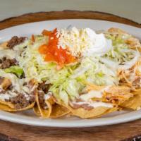 Nachos Supreme · Served with chicken, beef, beans. Lettuce, sour cream, tomatoes, and cheese.