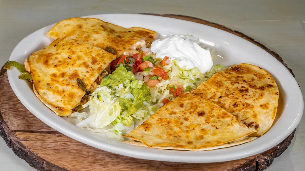 Quesadilla Deluxe · Choice of Grilled Chicken or Steak Cooked With Onions. Bell peppers and tomatoes topped of With lettuce Sour cream and guacamole.