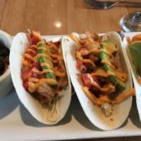 Grilled Shrimp Tacos · 12 grilled chili marinated shrimp in warm flour tortillas served with pico de gallo, avocado...