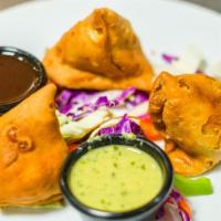 Meat Samosa · Triangle pies, stuffed minced lamb and spices.