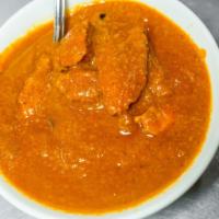 Hot Madras Chicken · South Indian curry, tomatoes, onions, coconut and spices. Served with steamed aged white bas...