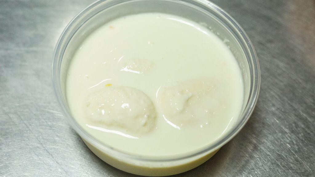 Rasmalai · Flattened balls of paneer, cream and cardamom.