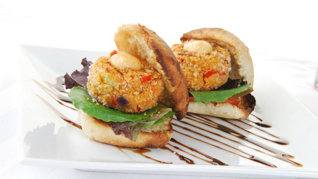Crab Cakes · Patty stuffed with mouth watering crab meat served with a drizzle of tartar sauce.