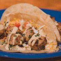 Grilled Lemon Ahi Tuna Taco · Lemon Pepper gilled ahi tuna topped with our Cilantro White Sauce, stuffed with cabbage, tom...