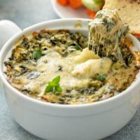 Spinach & Artichoke Dip · A creamy mixture of spinach, artichoke hearts, and cheeses. Served to bubble hot with freshl...