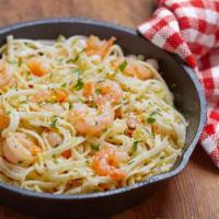 Shrimp Scampi · Large gulf shrimp roasted in a rich lemon garlic butter sauce and served over a bed of spagh...