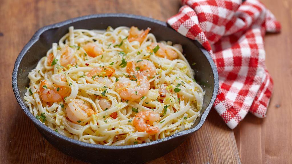 Shrimp Scampi · Large gulf shrimp roasted in a rich lemon garlic butter sauce and served over a bed of spaghetti pasta. Served with customer's choice of bread and salad.