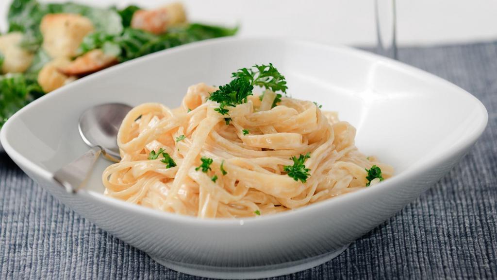 Fettuccini Alfredo · Rich and creamy alfredo sauce served at top customer's choice of marinated roasted chicken breast or seasoned grilled shrimp and nestled on a bed of fettuccini. Served with customer's choice of bread and salad.