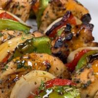 Mediterranean Chicken Skewers · Grilled marinated chicken with vegetables on a skewer, brushed with spicy honey glaze served...