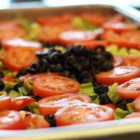 House Salad  · Spring Mix lettuce topped with Green & Black olives, Tomatoes, & Pepperoncini .