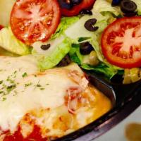 Chicken Parmigiana · Traditional chicken parmesan served over a bed of spaghetti.