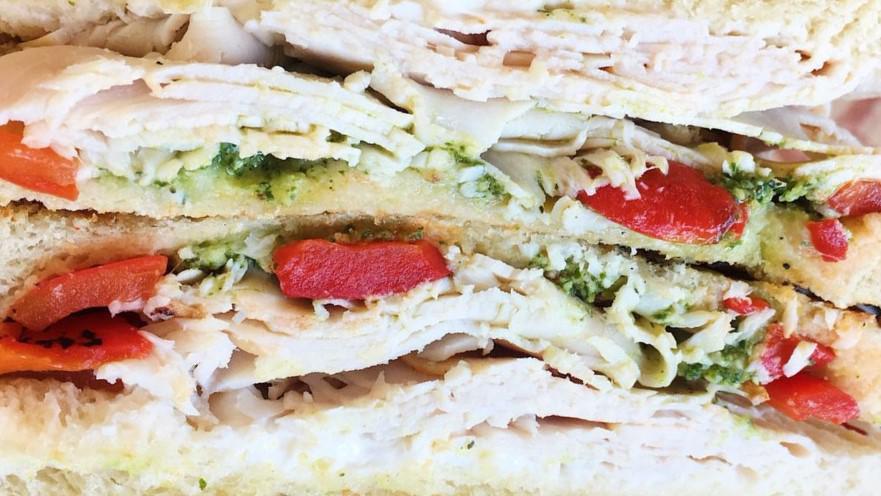 Hot Mama · Smoked turkey, cream cheese, pesto, tomato, onion and roasted red peppers, served on sourdough bread.