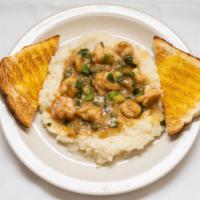 Shrimp & Grits · Shrimp over a bed of grits topped with spicy etouffee roux and toast.