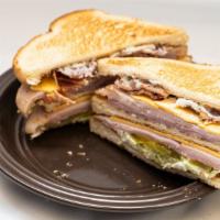Ham & Turkey Club · This Ham and Turkey club sandwich is piled high with ham, turkey, bacon, lettuce, pickles an...