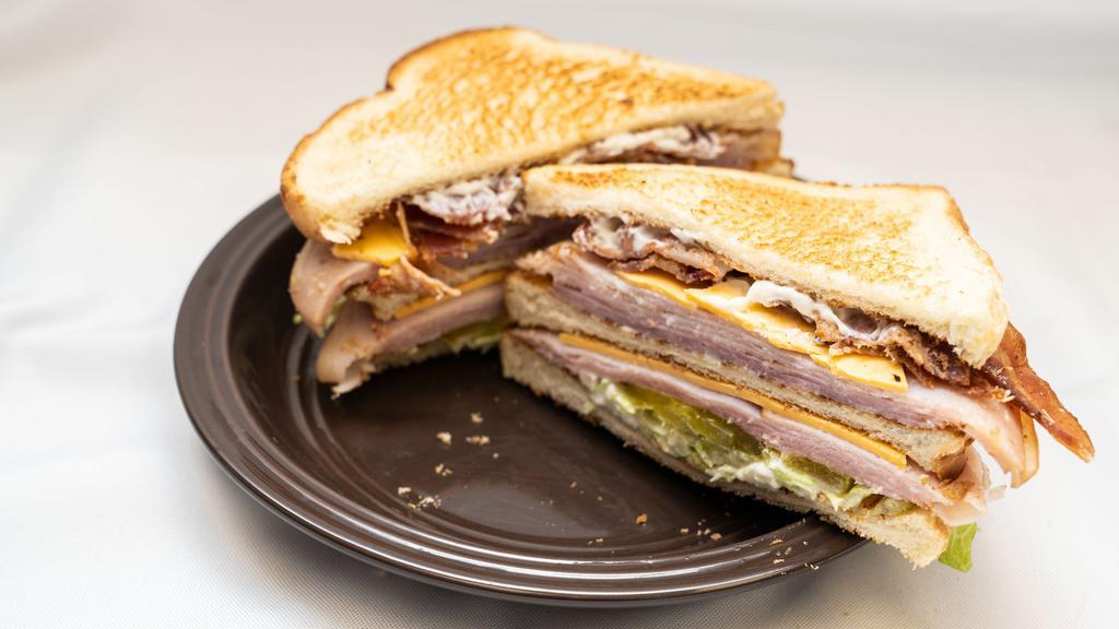 Ham & Turkey Club · This Ham and Turkey club sandwich is piled high with ham, turkey, bacon, lettuce, pickles and mayo.