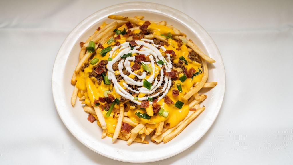 Fully Loaded Fries · Shoestring Fries topped with seasoned ground beef, bacon bits, green onion, cheese, and sour cream