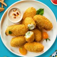 Crispy Jalapeño Poppers · Fried jalapeños filled with gooey melty cheese, served with ranch.