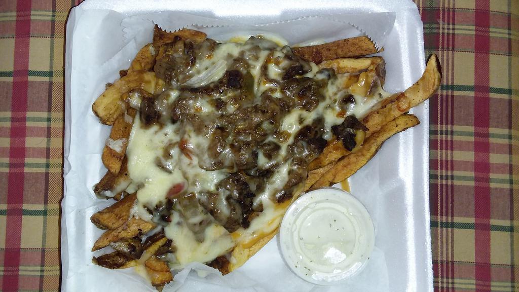 Philly Fries · A basket of fresh cut fries topped with Philly steak, cheese, onions, bell peppers with a side of ranch.