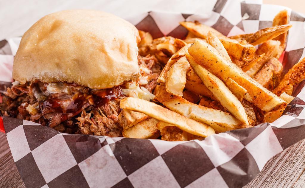 Pulled Pork Sandwich · Pulled Pork covered in bbq sauce on a sweet sourdough bun. Topped with slaw upon request.