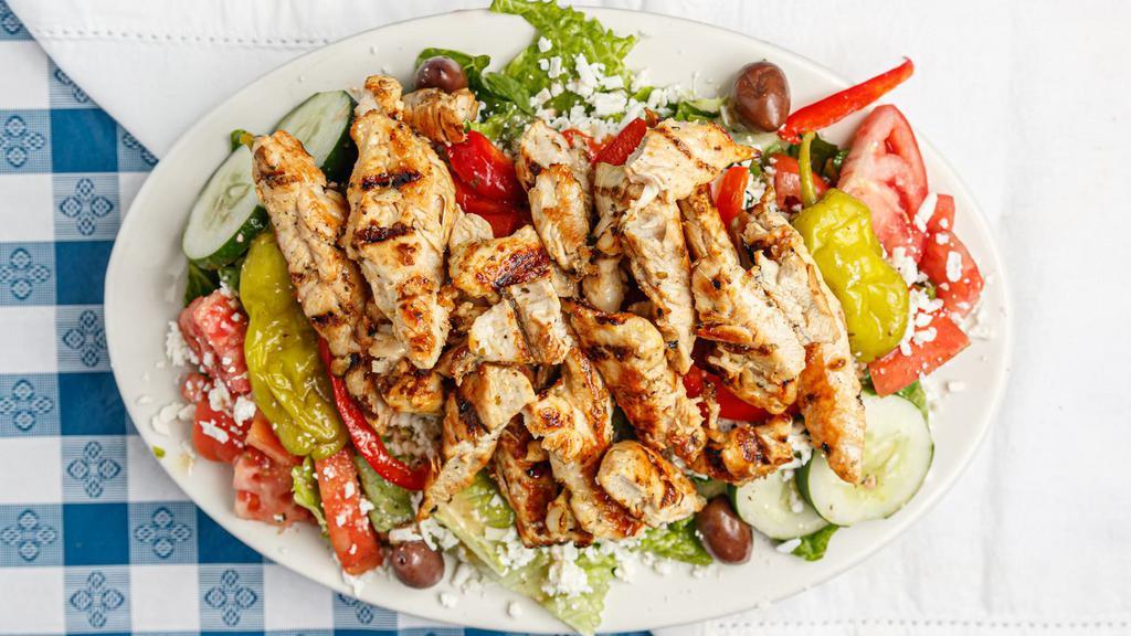 Mediterranean Chicken Salad · Greek salad topped with grilled marinated chicken and homemade Greek dressing.