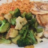 Vallarta Pollo · Grilled chicken breast covered with cream sauce. Served with rice, grilled vegetables, and t...