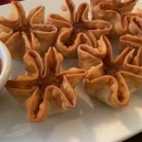 Crab Rangoon · Crab meat mixed with cream cheese and seasonings, then folded into wontons and cooked to gol...