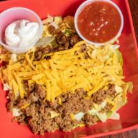 Taco Salad · A crisp bed of lettuce, covered in crumbled corn tortilla chips, our beef taco meat, tomato,...
