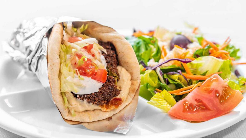 Falafel Pita- · Fried ground chickpeas with herbs wrapped in a pita served with hummus, lettuce, tomatoes, tzatziki sauce and pepper relish. Veggie.
