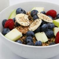 Raw Granola · granola topped with fruit and served with cashew-almond milk