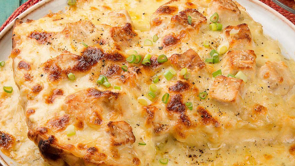 Pollo Gratinado · Grilled chicken chopped with onions served in a sizzling skillet of melted cheese.