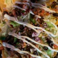 Loaded Nachos · Fresh tortilla chips, queso cheese, shredded lettuce, diced tomatoes, diced onions, black ol...