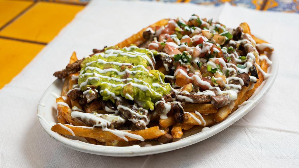 California Fries · Choice of protein (recommended: carne asada), seasoned French fries, queso, topped with pico de gallo, guacamole and sour cream.