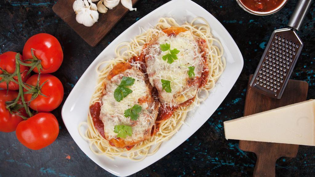Chicken Parmesan · Parmesan chicken breast over spaghetti, topped with marinara served with a side of fresh-baked breadsticks.