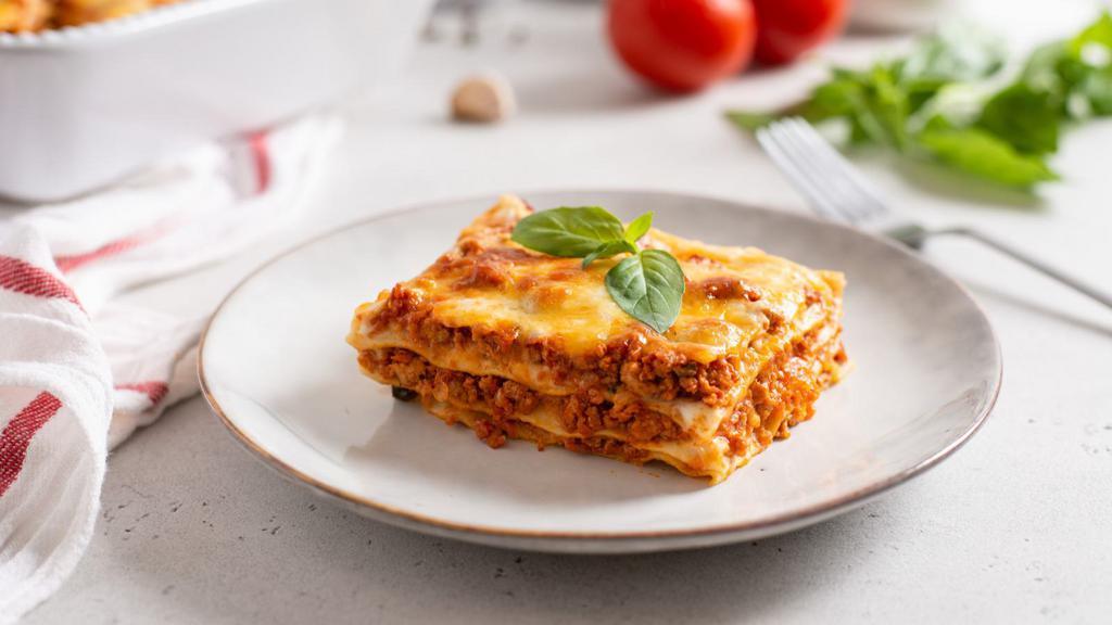 Beef Lasagna · Layers of pasta filled with minced beef, marinara, and cheese then baked to perfection and served with a side of fresh-baked breadsticks.