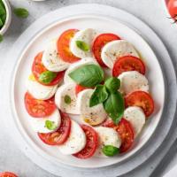 Mozzarella Caprese · Fresh mozzarella, fresh basil, tomatoes, and balsamic glaze.