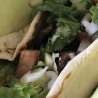 Gyro Sandwich · Gyro wrapped in white pita bread with tomato, lettuce, and tzatziki sauce. Served with your ...