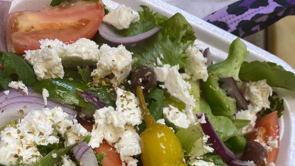Greek Salad · Mixed green lettuce, red tomato, chilled cucumbers, feta cheese, imported kalamata olives, sweet onion, green pepper, pepperoncinis & topped with our special house dressing.