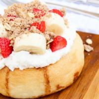 Bananas About You Cinnamon Roll · Banana frosting w/ banana, strawberries, and pie crumble.