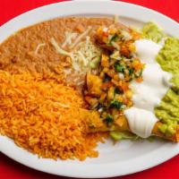 Flautas · Chicken or beef topped with lettuce, tomatoes, sour cream and guacamole. Served with rice an...