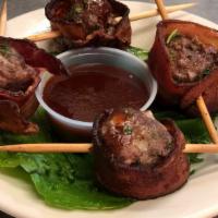 Hog Balls · Four pepperjack cheese and onion stuffed meatballs, wrapped in bacon and served with a side ...