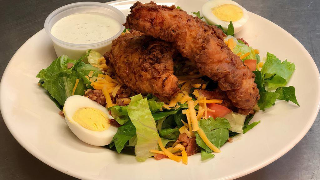Chicken Tender Salad · Romaine topped with cheese, tomato, boiled egg, bacon and buttermilk battered chicken tenders.
