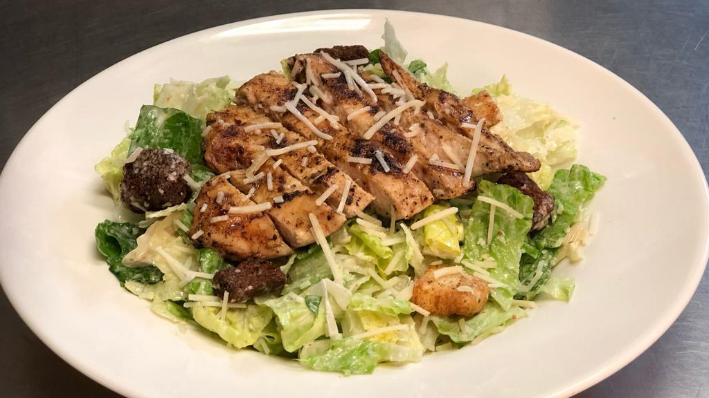 Chicken Caesar Salad · Romaine topped with grilled chicken, parmesan cheese, croutons and Caesar dressing.