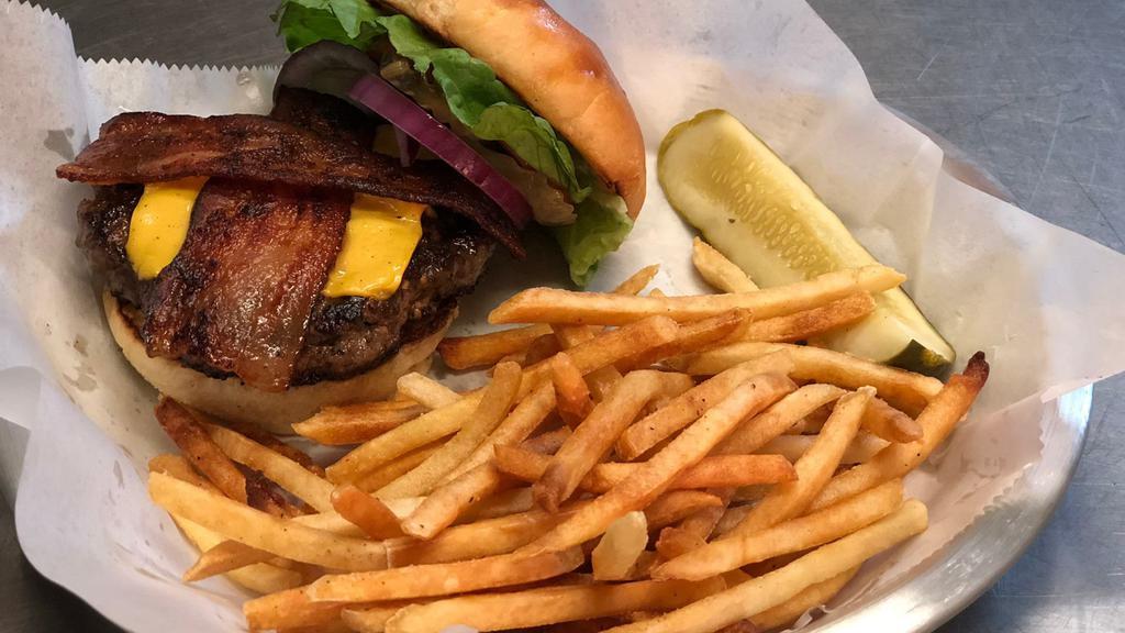 Juicy Brewski · Cheese and pepper stuffed Angus beef topped with bacon, American cheese, lettuce, tomato, pickle, onion, mustard and mayo on a brioche bun.