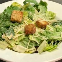 Side Caesar · Lettuce topped with parmesan cheese, croutons and Caesar dressing on the side.