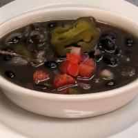 Black Beans · Black beans slow simmered with bacon, tomato, peppers, onions and spices.
